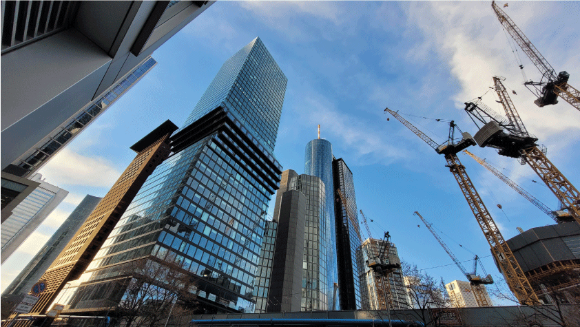 skyscrapers and construction site with cranes
